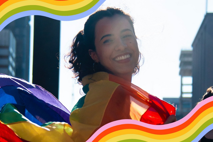 woman with pride flag on shoulders