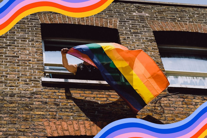 pride flag waving out of window