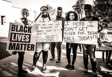 Black Lives Matter sign holders, protesters