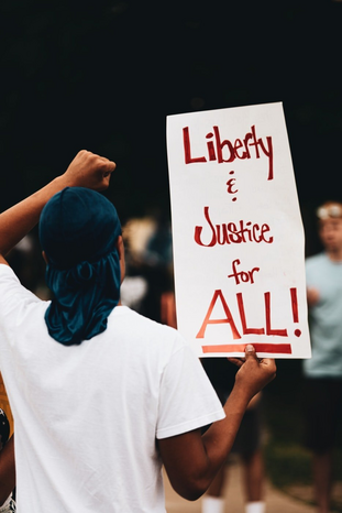liberty and justice for all protest sign by Logan Weaver