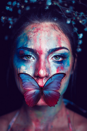 Colorful butterfly and paint on woman\'s face