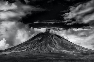 Black and white photo of active volcano eruption