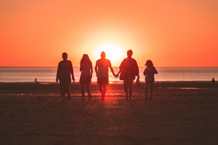 Family on the Beach by Kevin Delvecchio from Unsplash