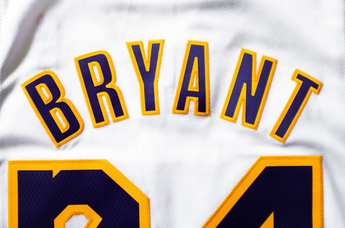 Kobe Bryant Lakers jersey; white, yellow and purple.