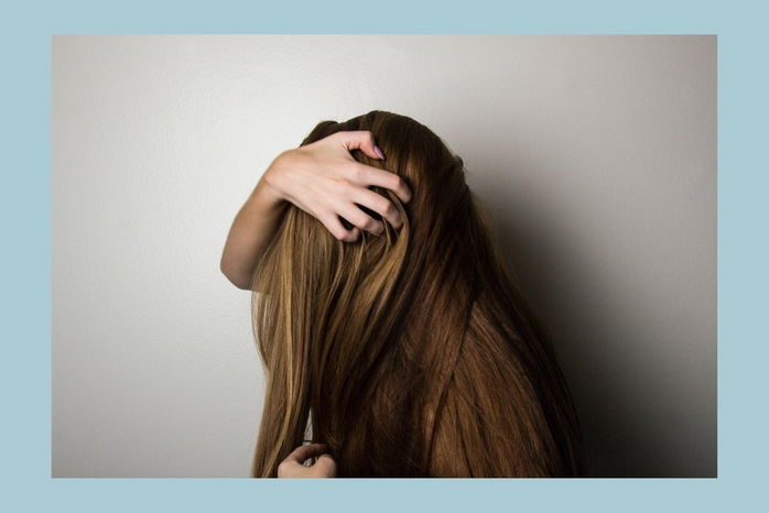 woman covering face with her hair