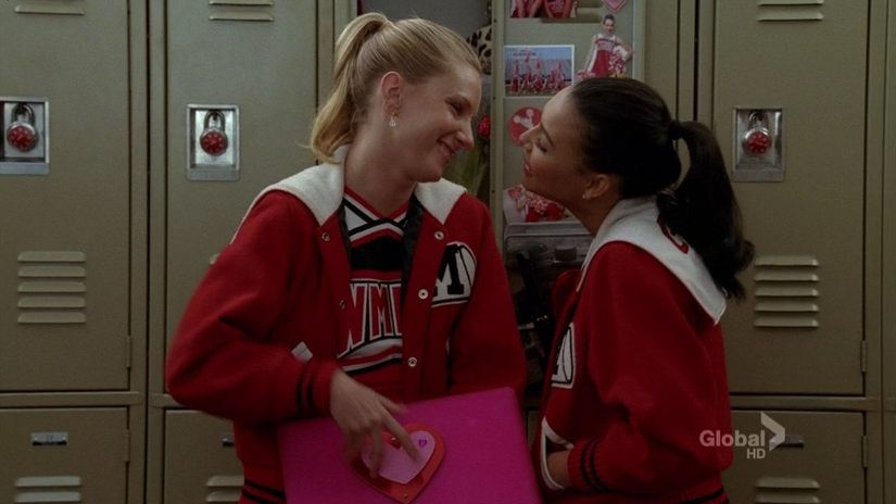 Brittany and Santana: two characters on the TV show \"Glee\" in front of school lockers