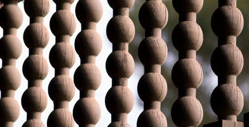 close-up of hanging wooden bead decor against outdoor background