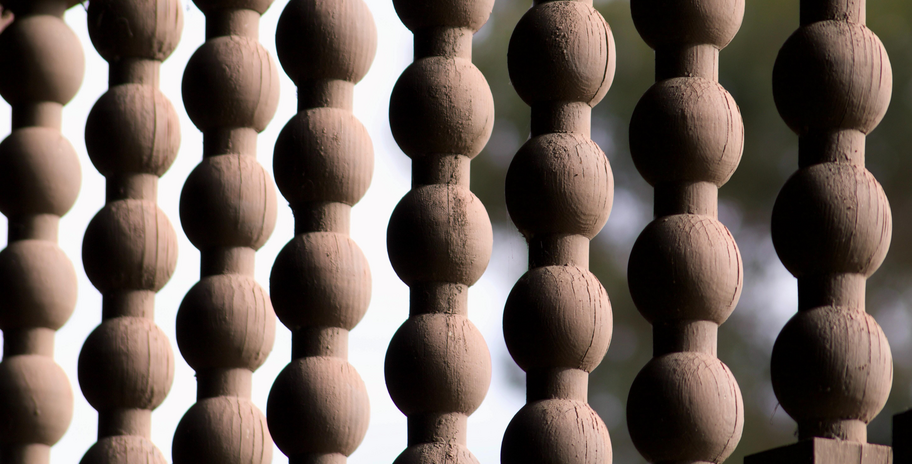 close-up of hanging wooden bead decor against outdoor background