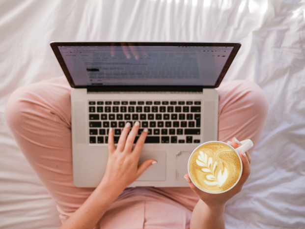 person holding latte while on laptop by Sincerely Media on Unsplash