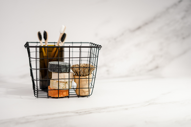 black basket with compostable toiletries