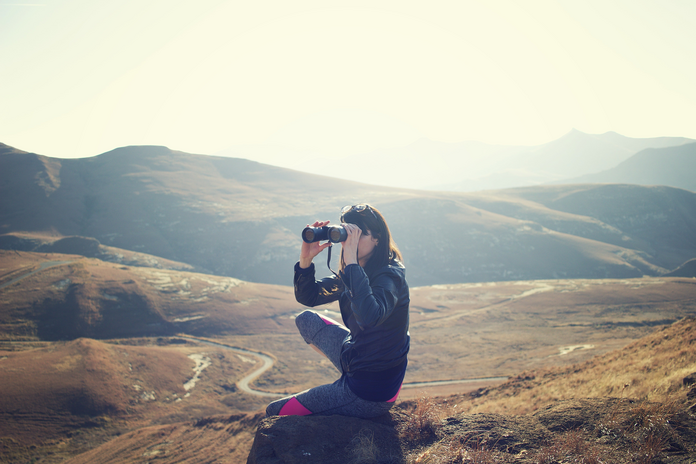 woman using binoculars at Golden Gate Highlands National Park, South Africa