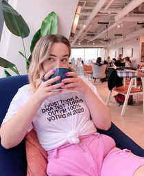 woman drinking tea in feminist shirt