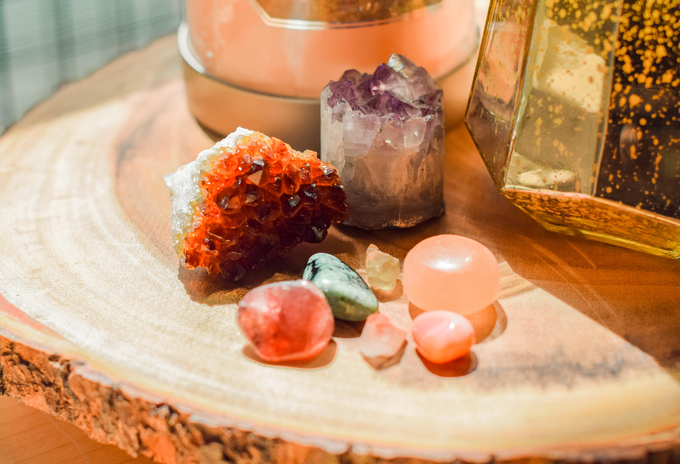 Crystals of all shapes, sizes and colours on a wooden table