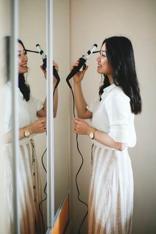 woman curling her own hair