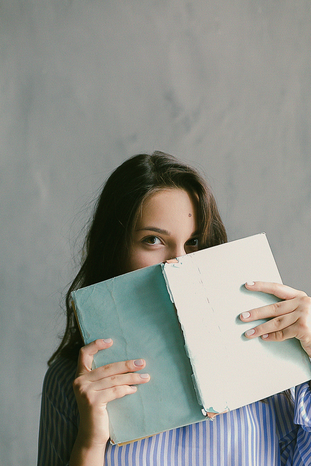 woman holding book by Daria Shevtsova