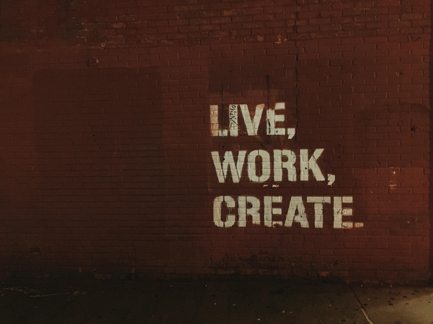 red brick wall with live, work, create