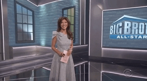 Julie Chen in front of big brother sign