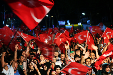 Group of Turkish people waving the Turkish flag