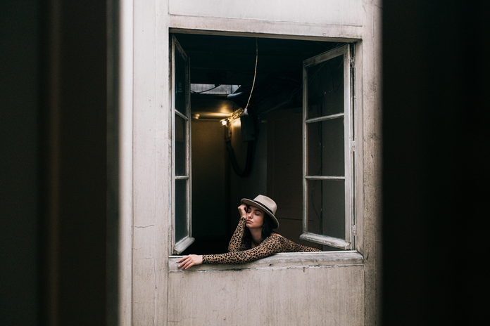 woman leaning out of a window