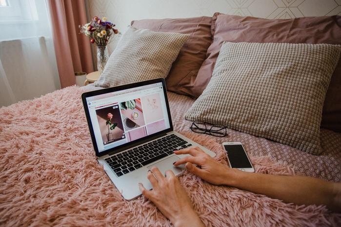typing on laptop in bedroom by Marta Filipczyk