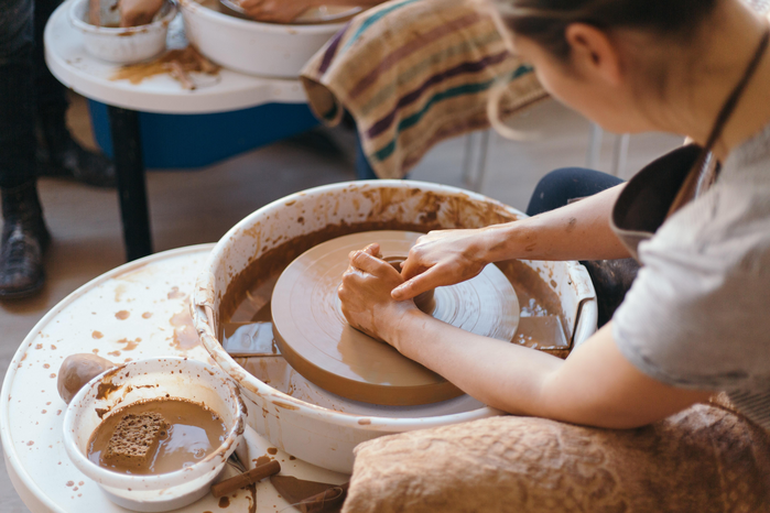 Woman on pottery wheel by Juliet Furst