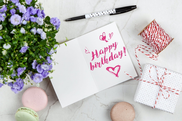 Happy birthday written in a card by Giftpunditscom