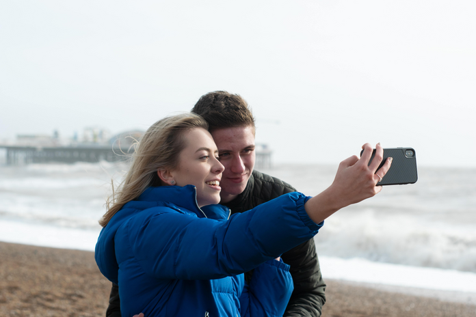 Couple on beach taking a selfie
