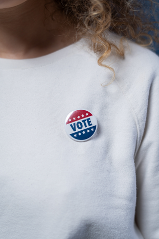 Vote Pin on a White Sweater by cottonbro