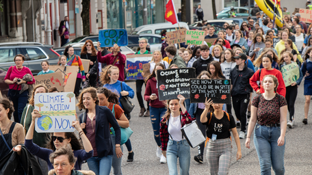 crowd of people marching at a climate change rally