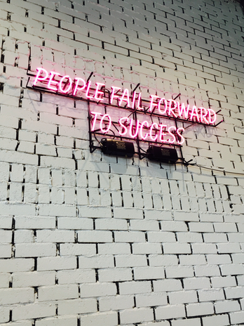 neon sign "people fail forward to success"