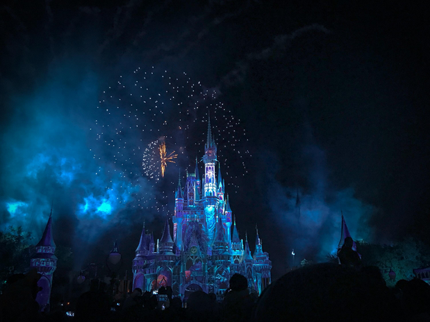 cinderella castle at night with fireworks