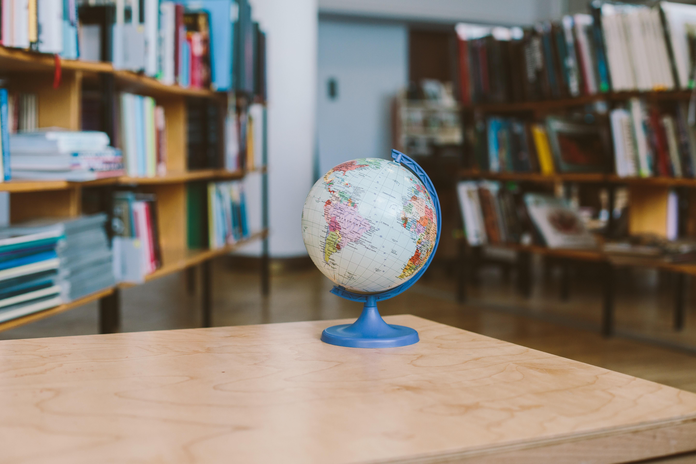 Globe of the world on table in a library.