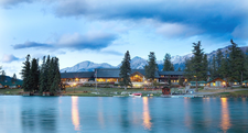 Fairmont main lodge in Jasper National Park with mountains, trees, and lake