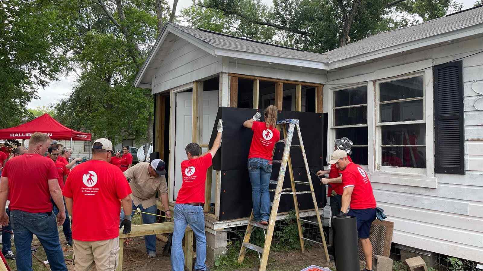 Volunteers work on repairing a U.S. veteran's home
