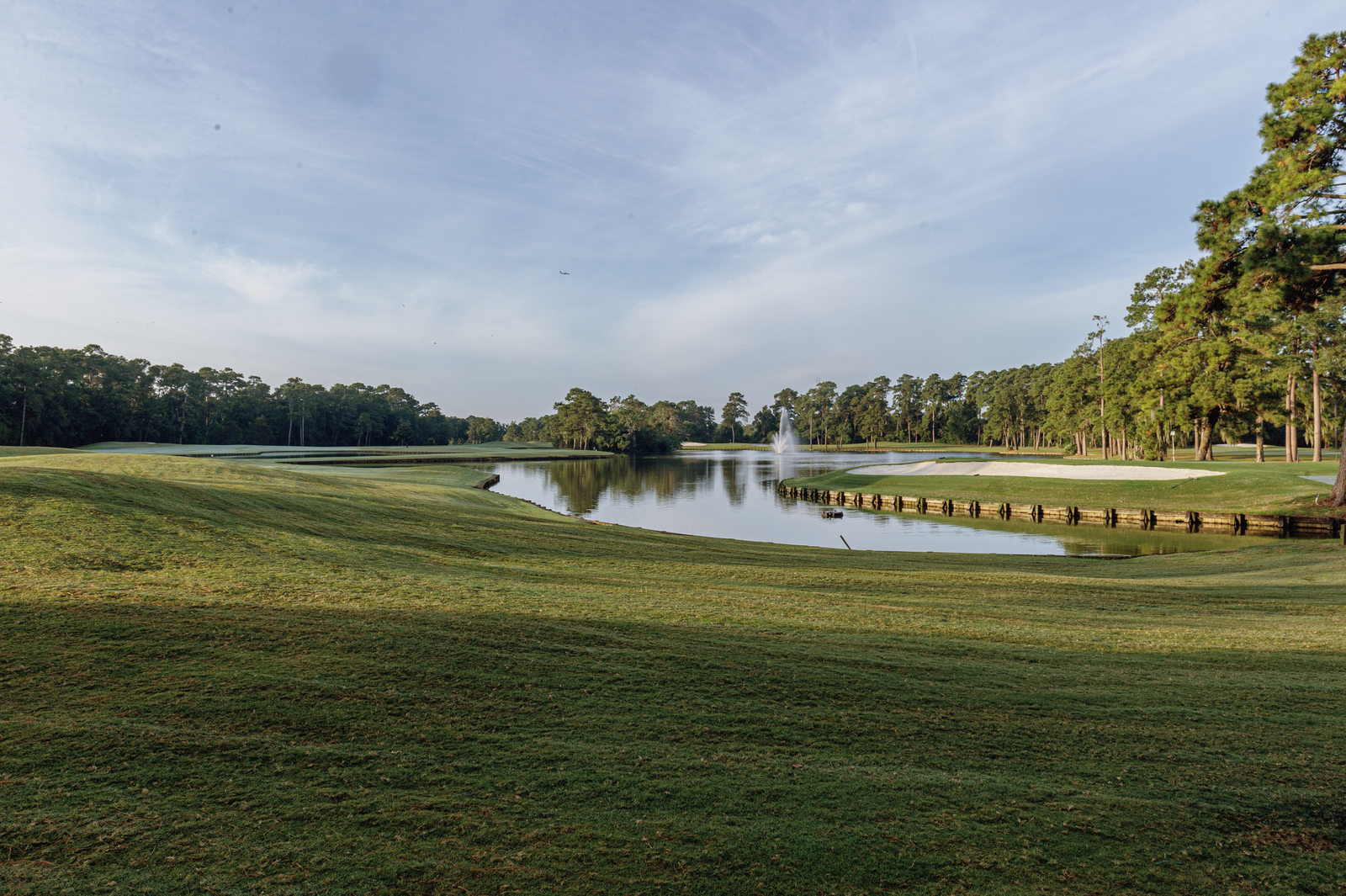 Golf course with a pond at the center.