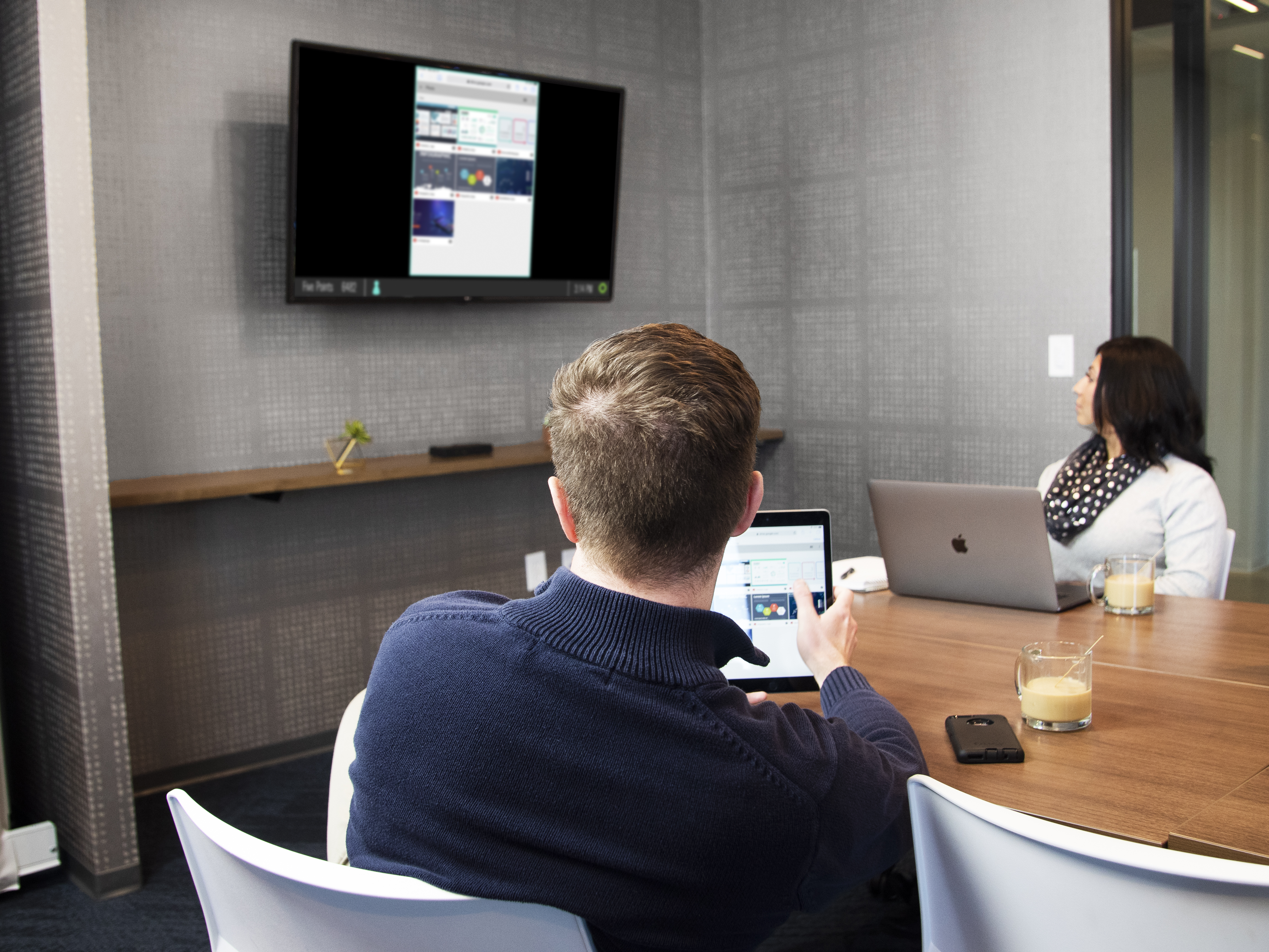 Employees using screen sharing in conference room
